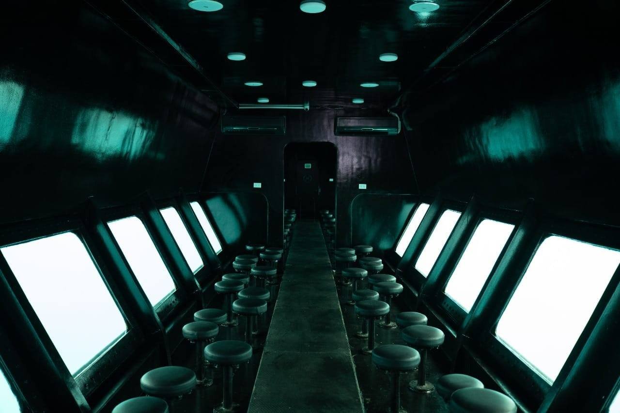 Underwater viewing cabin with seats beside side windows