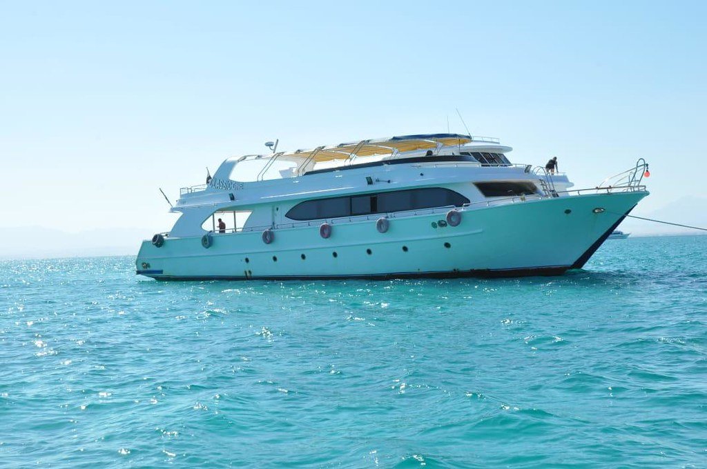 White excursion boat with a shaded upper deck on the Red Sea