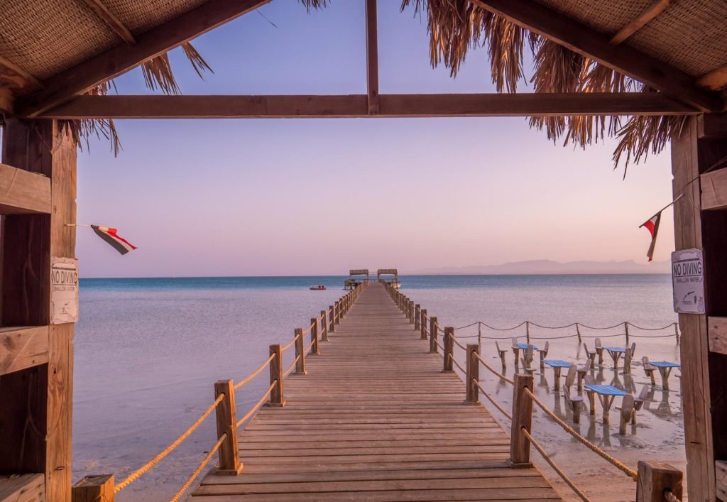 Wooden pier extending from a thatched shelter at Orange Bay