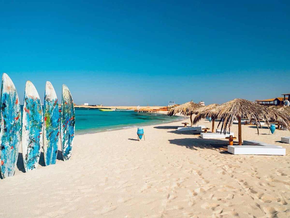 Sandy beach and shaded seating shown in our Paradise Island trip gallery