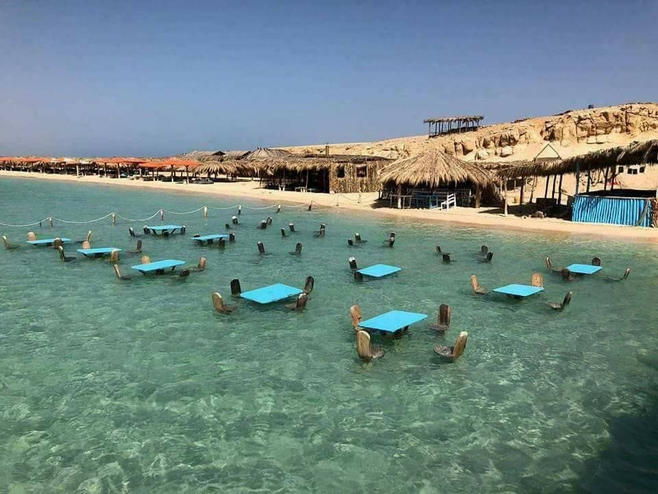 Shallow beach water and seating at Orange Bay