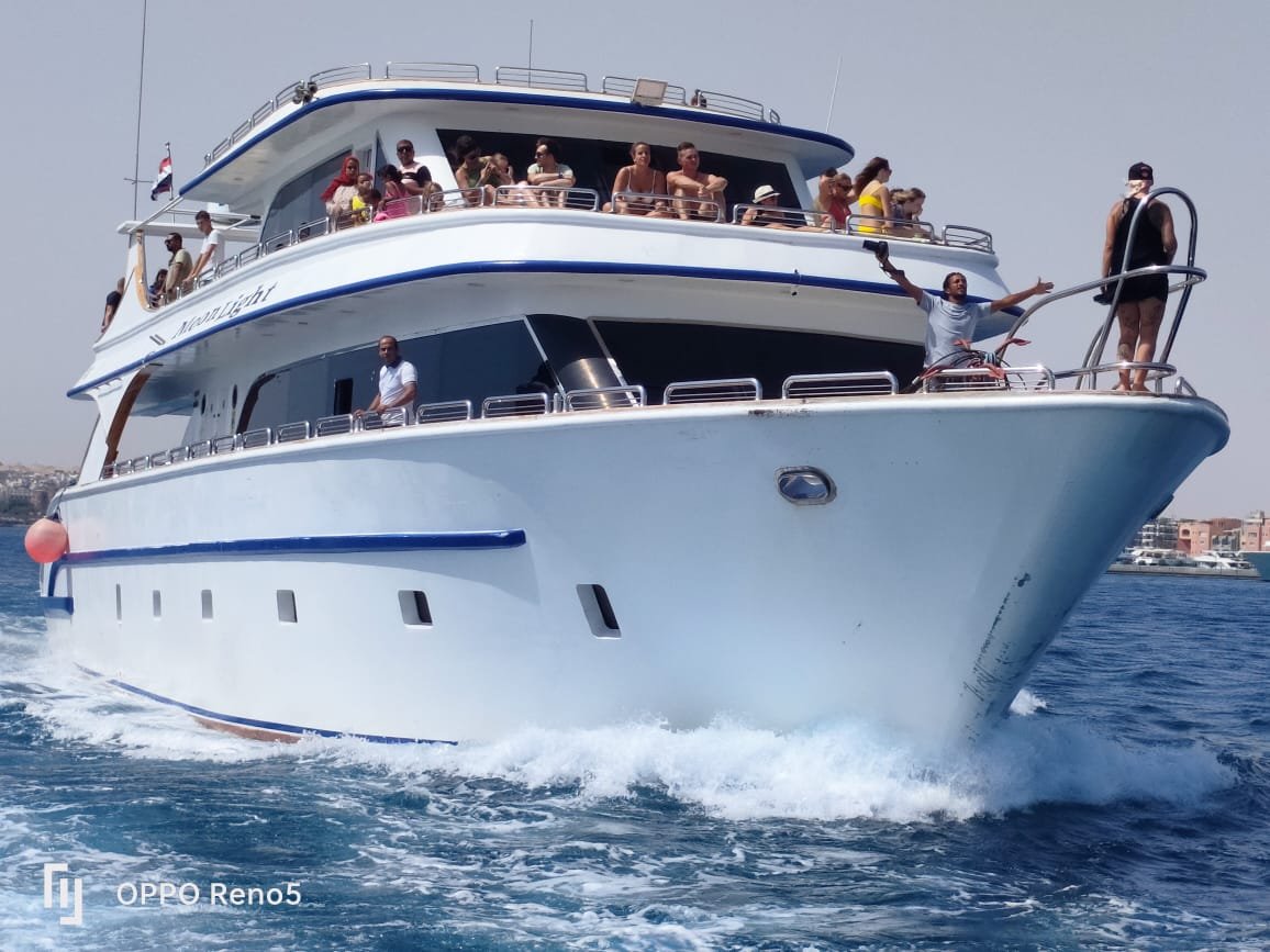 Passengers aboard a two-deck excursion boat