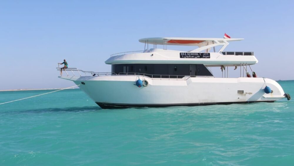 White excursion boat anchored in clear turquoise water