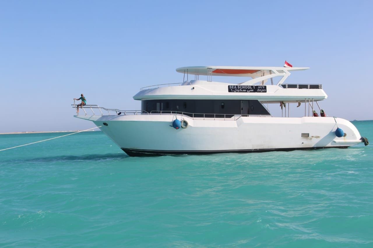White excursion boat anchored in clear turquoise water
