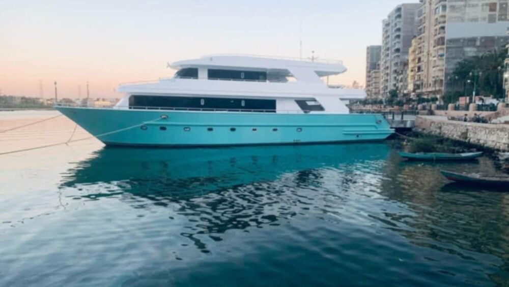 Motor yacht moored beside waterfront buildings