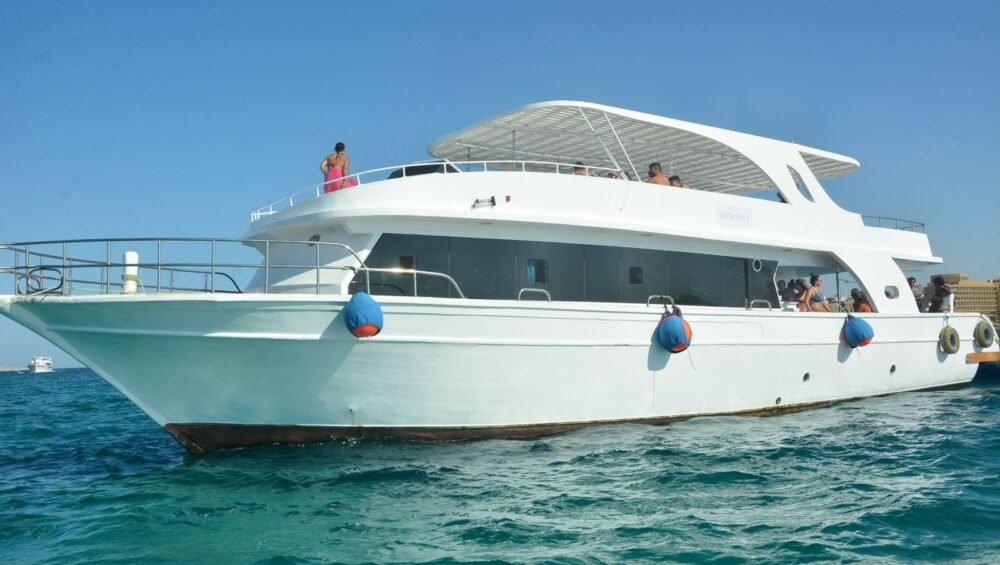 White excursion boat on calm coastal water