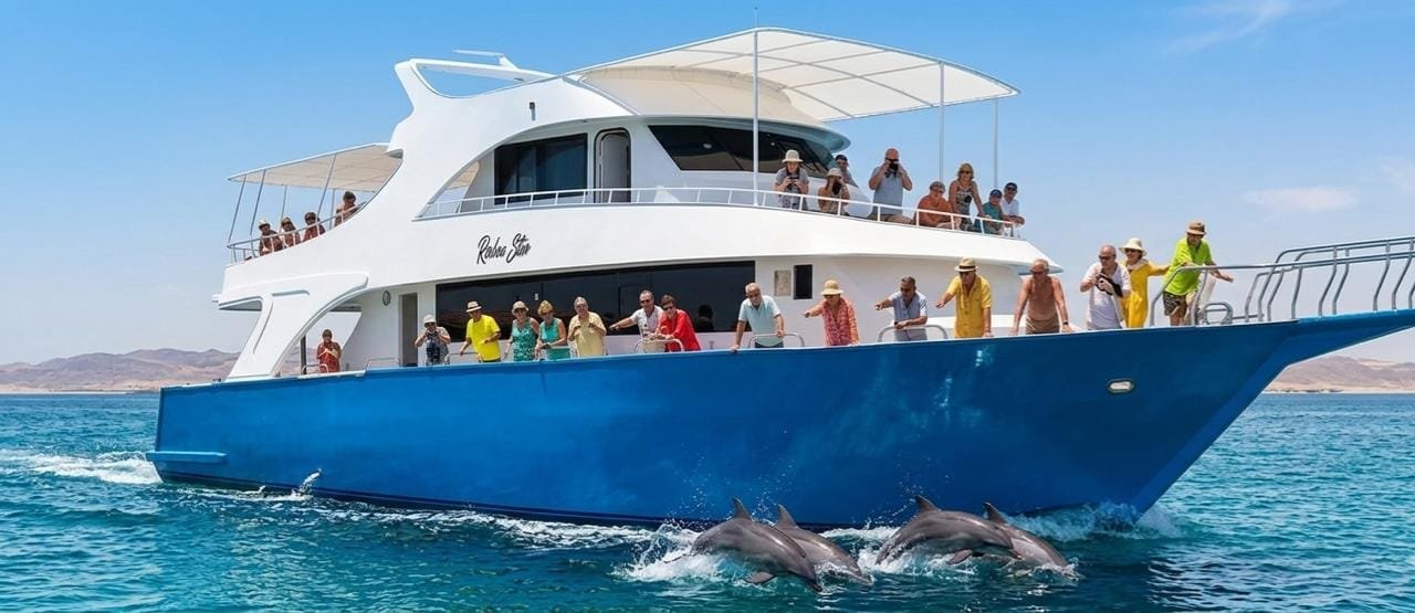 Blue and white excursion boat with dolphins near its bow