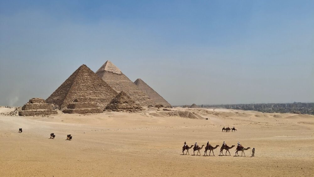 Camel caravan crossing the desert near the Pyramids of Giza
