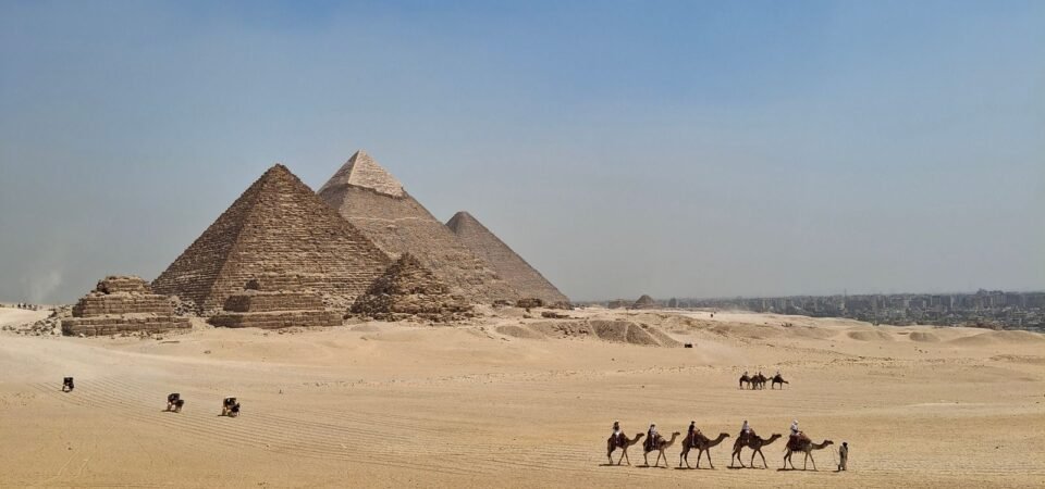 Camel caravan crossing the desert near the Pyramids of Giza