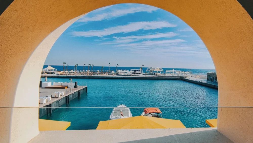 Daytime view through an arch towards Hurghada marina