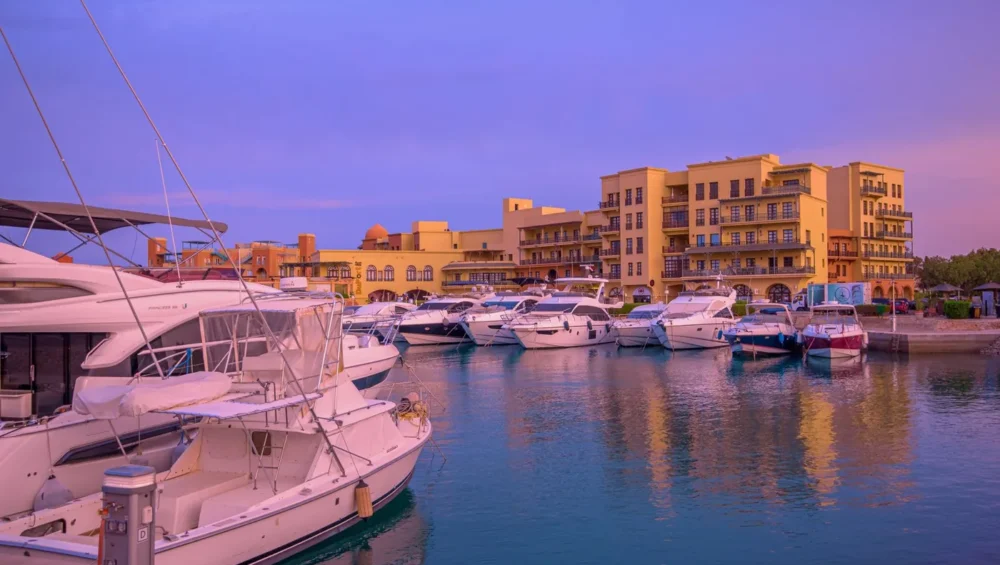 Moored yachts and colorful waterfront buildings at Hurghada Marina